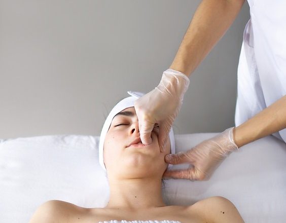 What is the buccal massage technique?